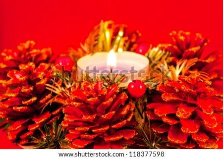 christmas card with candle and red pinecone
