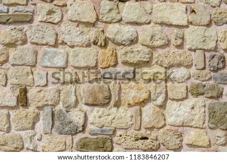 Wall with stones in random size, textured wall for background
