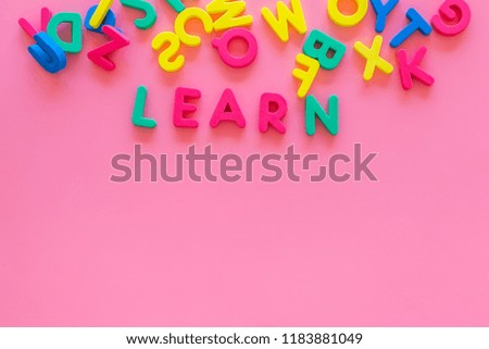 Children learn read concept. Word learn written by plastic letters on pink background top view space for text