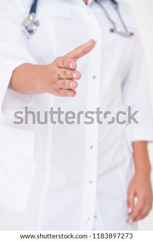 Woman doctor hand offering help for handshake. Health care concept