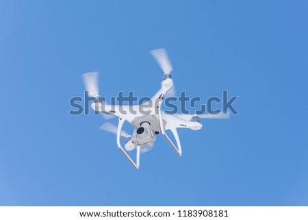 Drone flying overhead in blue sky