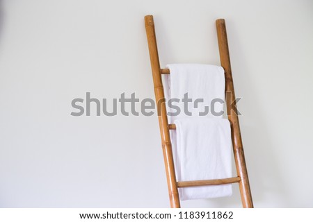 White towels hanging on bamboo made clothesline