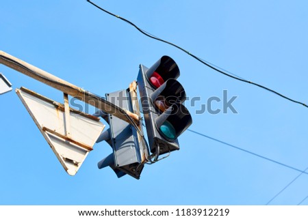 traffic lights and road signs against sky