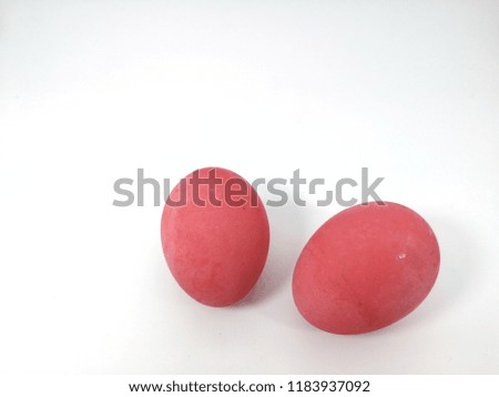 Eggs is pink color on the white paper is background.