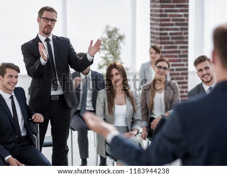 young businessman asks the speaker at a business meeting