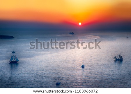 Sailing Boats and Cruise Ships Near Santorini Island at Dusk. Picture Taken at Golden Hour.Horizontal Image