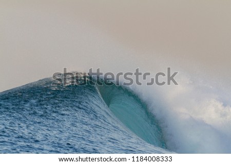perfect island wave crashing in ocean
