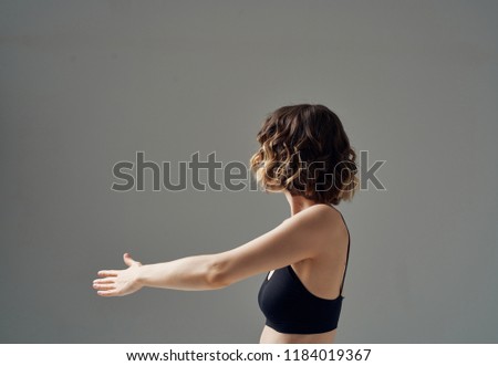 woman doing sports on a gray background                             