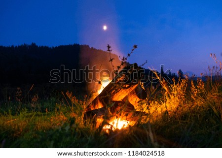 bonfire at sunset in the mountains