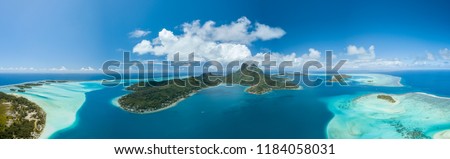 Panoramic aerial view of luxury overwater villas with palm trees, blue lagoon, white sandy beach and Otemanu mountain at Bora Bora island, Tahiti, French Polynesia (Bora Bora Aerial) Royalty-Free Stock Photo #1184058031