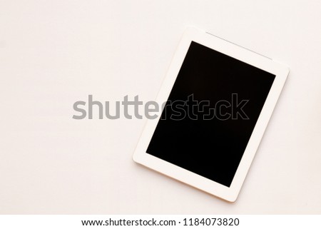 Close up top view to white tablet computer isolated and Empty blank screen black on white background view. Flat lay creative ideas with blank mock up. Front view of the Business.