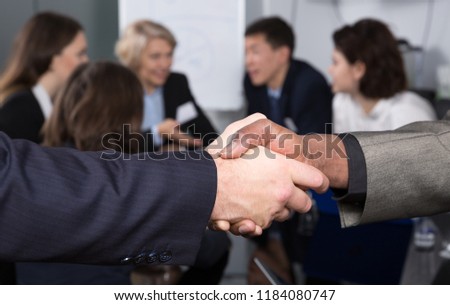 Closeup of businessmen handshake as sign of closing deal on meeting