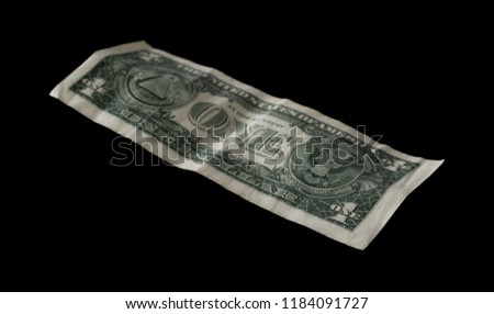 One dollar bill isolated on black background
