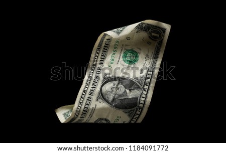 One crumpled dollar bill isolated on black background