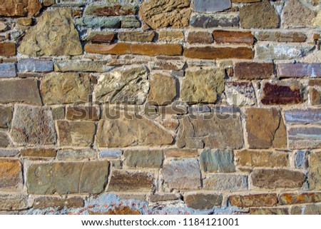 Close-up of a Fragment of the wall of this medieval castle. Fortress wall of large stone.