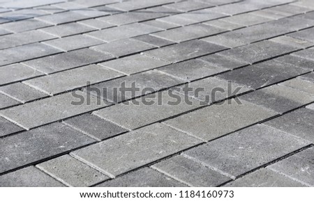 Concrete or cobble gray pavement slabs or stones  for floor, wall or path. Traditional fence, court, backyard or road paving.
