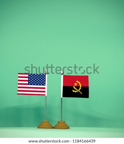 USA and Angola flag with light green background