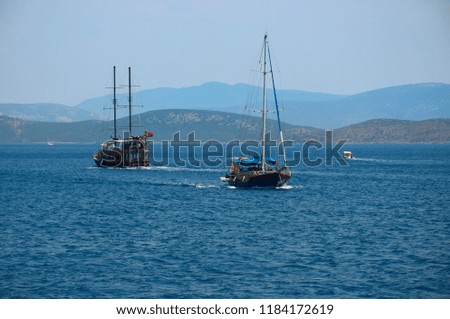 Water excursion in Turkey. Two ships diverge in the Sea. Blue sea and. Coast of the Aegean Sea. Turgutreis , Bodrum.mountains.