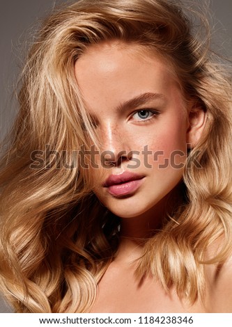 Blonde model with natural make up. Studio shot.  Royalty-Free Stock Photo #1184238346