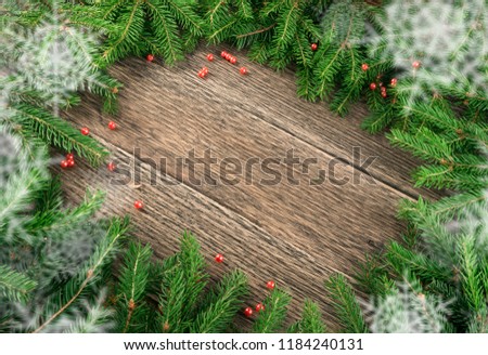 Christmas background with fir branches on wooden backdrop flat lay and top view. Yuletide floral frame decoration with copy space on wood table. Creative xmas tree border for New Year greeting card