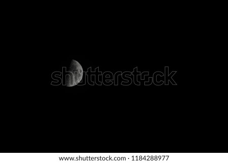 Picture of a half moon on a dark night middle left
