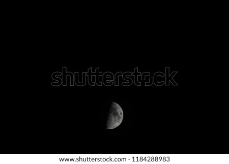 Picture of a half moon on a dark night middle bottom