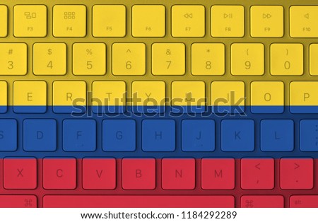 Colombian flag and computer keyboard in the background. Colombia flag