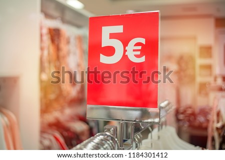 5 euros - image of the price tag during the sale in the shopping center, large red signboard