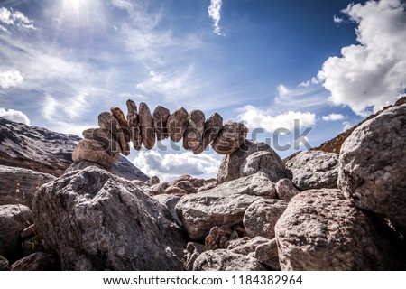 stone sculpture in the swiss alps. The theme is longevity, cohesion and trust. Royalty-Free Stock Photo #1184382964