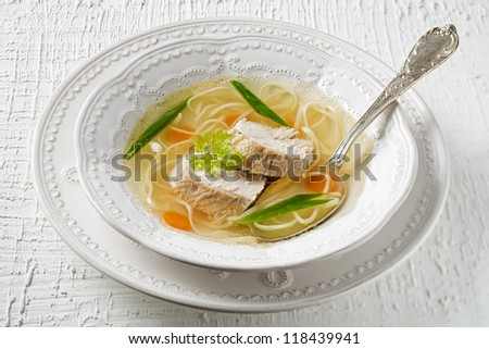 Chicken soup with noodles and meat close up shoot