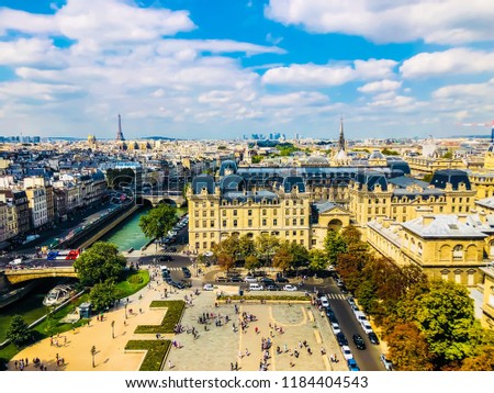 Ariel-view from the top of Notre Dame Cathedral capturing the scenic view of Paris city skyline with Eiffel tower in background.