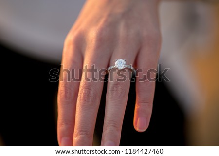 Engagement Ring On Woman's Hand During Sunset Royalty-Free Stock Photo #1184427460