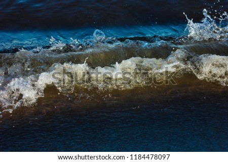 sea wave breaking hard with foam