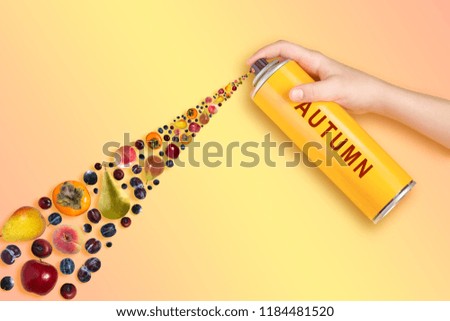 Different autumn fruits fly from spray can with inscription: autumn. Pastel gradient background. Minimal style. Creative idea, imagination and fantasy. Original autumn concept