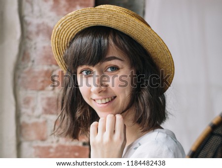 Portrait of smilling cute girl in hat in vintage room