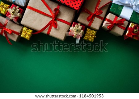Christmas background concept. Christmas gift box with red ball on green background.