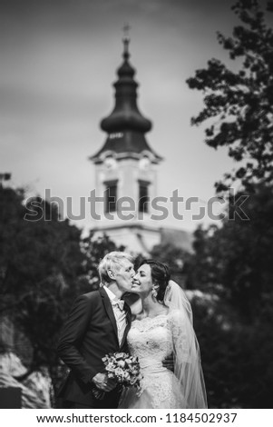 Wedding couple, rural church in background