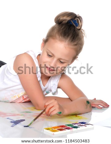 A little girl draws paints on her body. The concept of children's creativity, education and school. Isolated on white background.