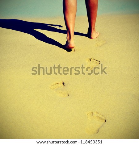 someone walking on the sand of a beach in the summer with a retro effect