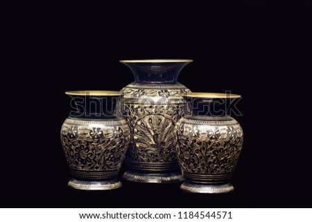 golden vases in a black background  Royalty-Free Stock Photo #1184544571