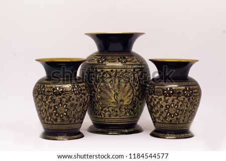 3 golden vases in a white background  Royalty-Free Stock Photo #1184544577