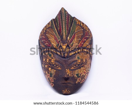 Indonesian mask in a white background  Royalty-Free Stock Photo #1184544586
