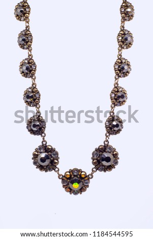 sunflower necklace in a white background  Royalty-Free Stock Photo #1184544595