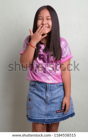Portrait of young cute Asian girl wearing stylish clothes