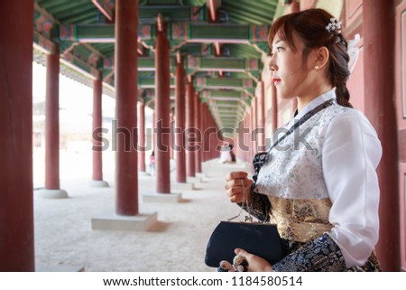 Beautiful Korean woman dressed Hanbok, Korean traditional dress, in Gyeongbokgung Palace, Seoul, South Korea