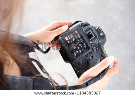 female tourist photographer is check her digital camera and setting. Technological concepts and tourism