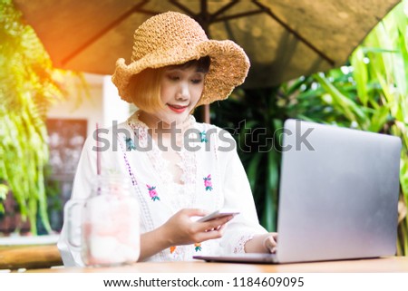 Asian business woman working in in coffee shop cafe with laptop.