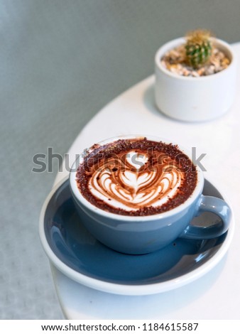 Hot Chocolate in a cup at coffee shop. hot drink with heart shaped latte art, Cafe with barista art concept.