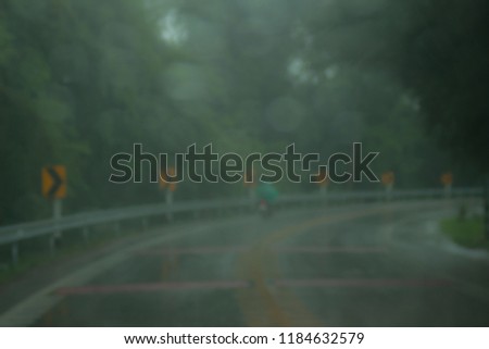 Blur, Road through forest with fog in rainny day