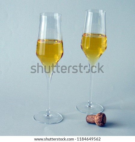 two glasses of spumante wine on white background